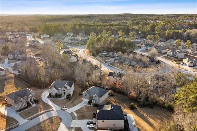 bird's eye view with a wooded view and a residential view