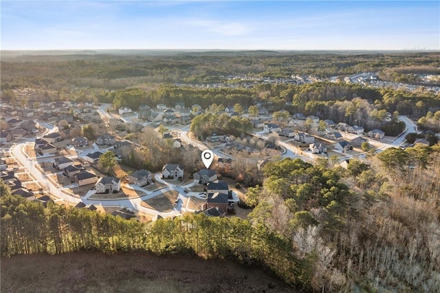 drone / aerial view featuring a view of trees and a residential view