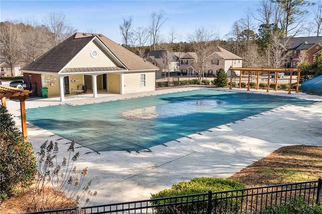 pool with a residential view, a pergola, a patio area, and fence
