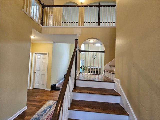 1988 Greensferry Gln, Lawrenceville, GA 30043 - stairway with a towering ceiling, baseboards, and wood finished floors