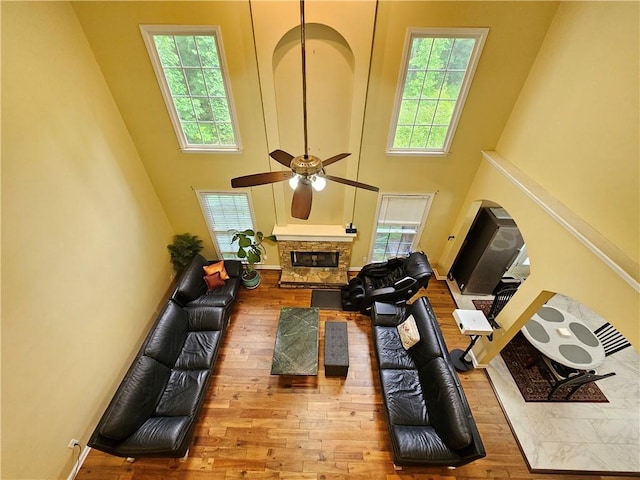 1988 Greensferry Gln, Lawrenceville, GA 30043 - living area featuring a high ceiling, hardwood / wood-style floors, plenty of natural light, a ceiling fan, and a fireplace