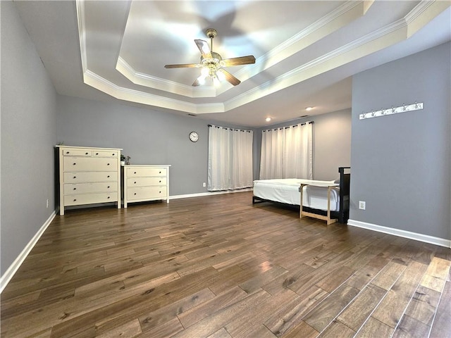 1988 Greensferry Gln, Lawrenceville, GA 30043 - unfurnished bedroom featuring a tray ceiling, crown molding, wood finished floors, and baseboards