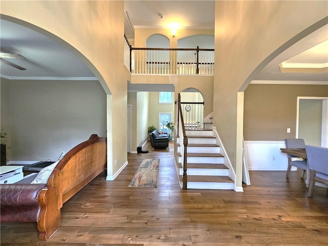 1988 Greensferry Gln, Lawrenceville, GA 30043 - entrance foyer with a ceiling fan, hardwood / wood-style floors, ornamental molding, arched walkways, and baseboards