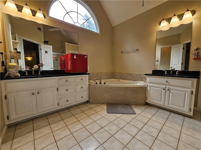 1988 Greensferry Gln, Lawrenceville, GA 30043 - full bath featuring lofted ceiling, vanity, a bath, tile patterned floors, and a ceiling fan