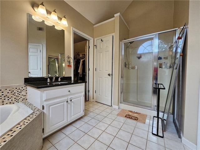 1988 Greensferry Gln, Lawrenceville, GA 30043 - bathroom featuring a stall shower, vanity, tile patterned flooring, a garden tub, and a spacious closet