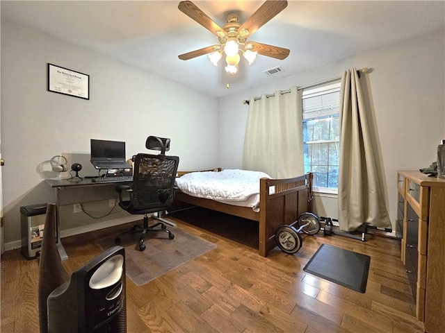 1988 Greensferry Gln, Lawrenceville, GA 30043 - bedroom with wood finished floors, an office area, and a ceiling fan