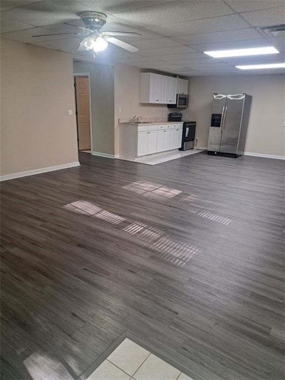 1988 Greensferry Gln, Lawrenceville, GA 30043 - unfurnished living room featuring dark wood-style flooring, baseboards, ceiling fan, and a sink