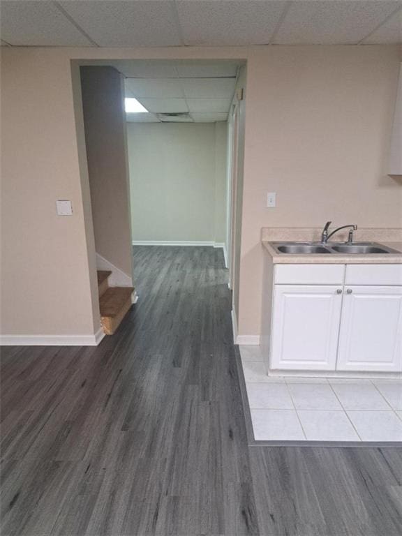 1988 Greensferry Gln, Lawrenceville, GA 30043 - corridor with a sink, a paneled ceiling, light wood-style flooring, baseboards, and stairs