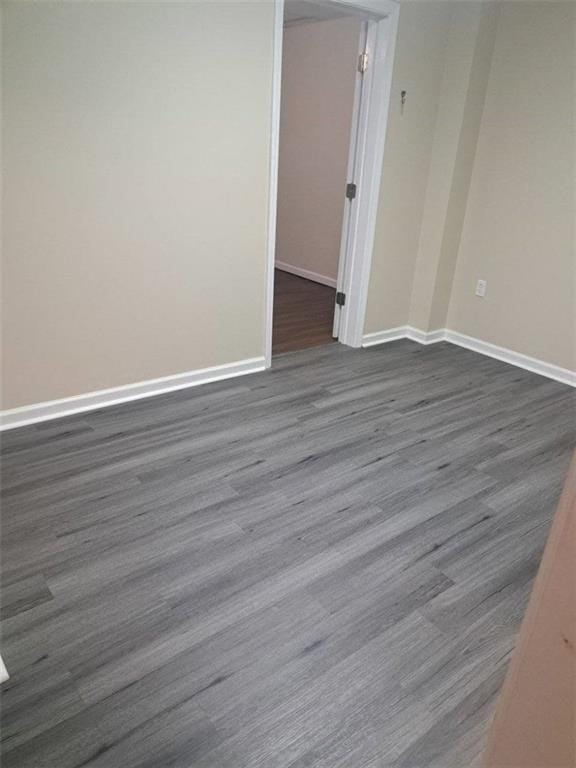 1988 Greensferry Gln, Lawrenceville, GA 30043 - unfurnished room with baseboards and dark wood finished floors