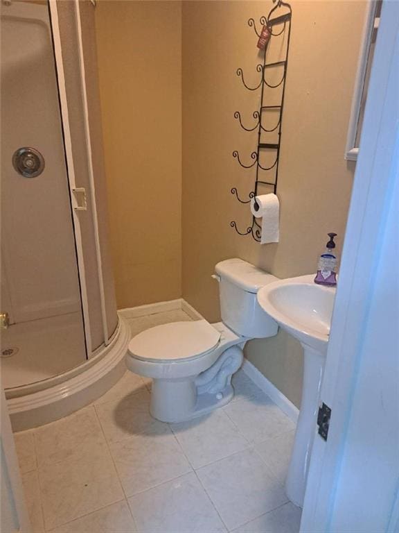 1988 Greensferry Gln, Lawrenceville, GA 30043 - bathroom with a stall shower, toilet, tile patterned flooring, and baseboards