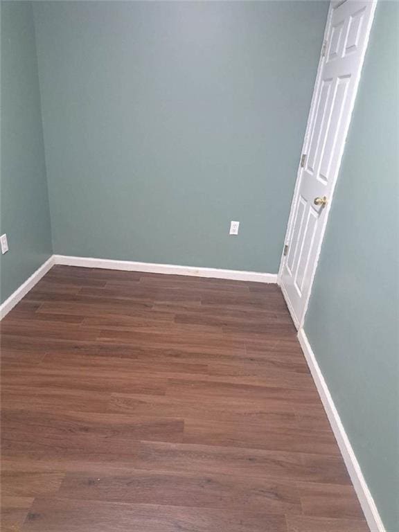 1988 Greensferry Gln, Lawrenceville, GA 30043 - empty room with baseboards and dark wood-type flooring