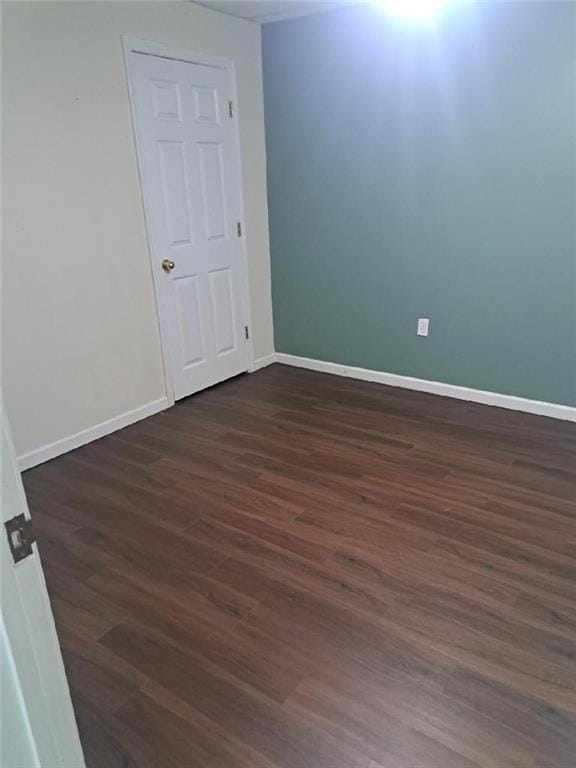 1988 Greensferry Gln, Lawrenceville, GA 30043 - unfurnished room with dark wood-type flooring and baseboards