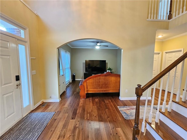 1988 Greensferry Gln, Lawrenceville, GA 30043 - foyer entrance with arched walkways, ceiling fan, a high ceiling, hardwood / wood-style floors, and ornamental molding