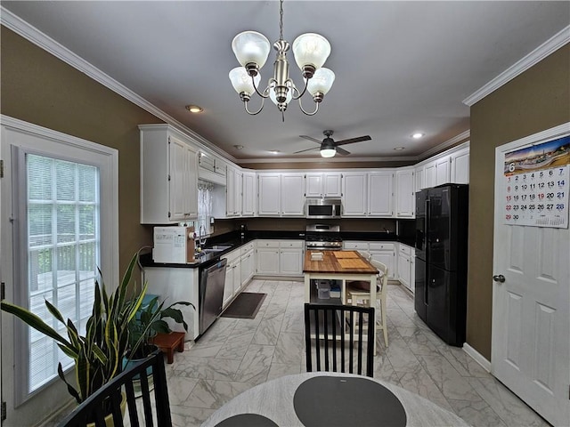 1988 Greensferry Gln, Lawrenceville, GA 30043 - kitchen featuring stainless steel appliances, light marble finish floors, a chandelier, crown molding, and ceiling fan