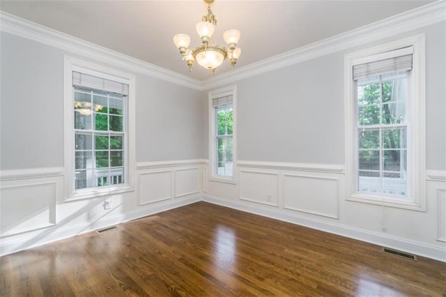 unfurnished room with a chandelier, wood finished floors, a wainscoted wall, and ornamental molding