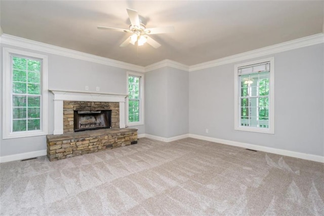 unfurnished living room featuring crown molding, plenty of natural light, a ceiling fan, and carpet flooring