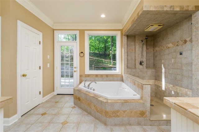 bathroom featuring tile patterned floors, a bath, a tile shower, crown molding, and baseboards