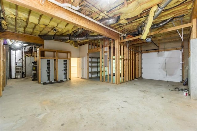 garage featuring water heater, a garage door opener, and heating unit