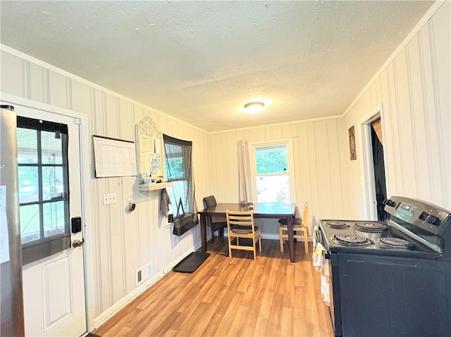 5167 Hiram Lithia Springs Rd, Powder Springs, GA 30127 - kitchen featuring black range with electric cooktop, ornamental molding, a textured ceiling, and light wood finished floors