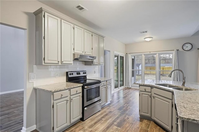 kitchen featuring electric range, a sink, visible vents, and under cabinet range hood