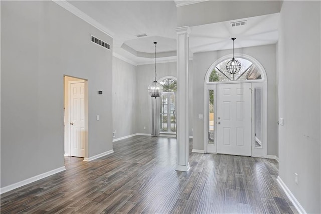 entryway with an inviting chandelier, plenty of natural light, and visible vents