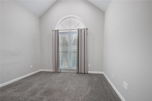 carpeted empty room with lofted ceiling and baseboards