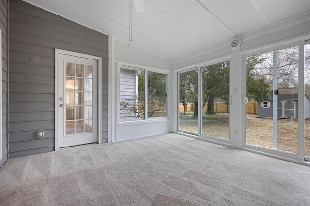 unfurnished sunroom featuring vaulted ceiling and a wealth of natural light