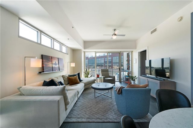 living room with ceiling fan and wood-type flooring