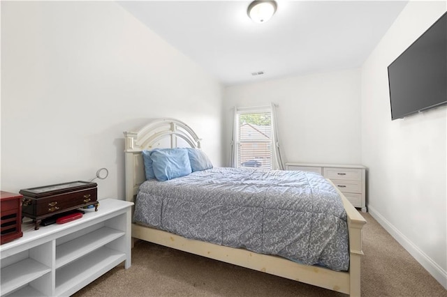 bedroom with dark colored carpet