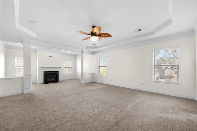 unfurnished living room featuring light carpet, a tray ceiling, and crown molding