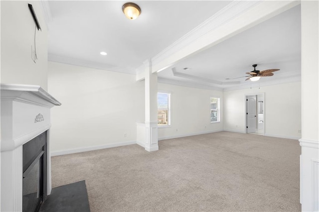 unfurnished living room with light carpet, ornamental molding, a raised ceiling, and ceiling fan