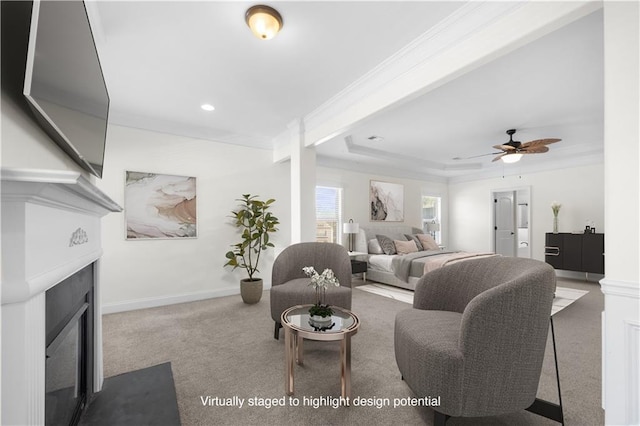 carpeted living room featuring ornamental molding, a raised ceiling, and ceiling fan