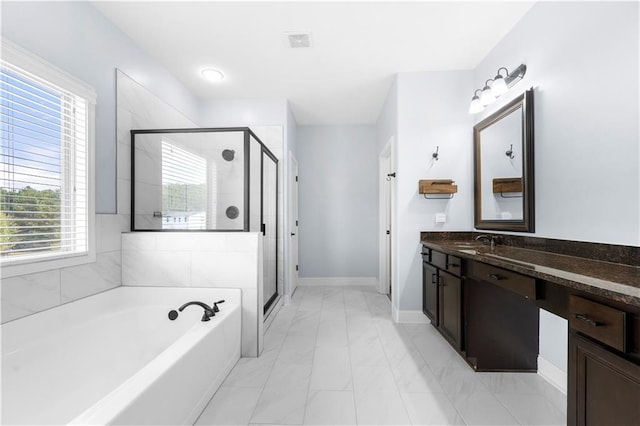 bathroom with vanity and independent shower and bath