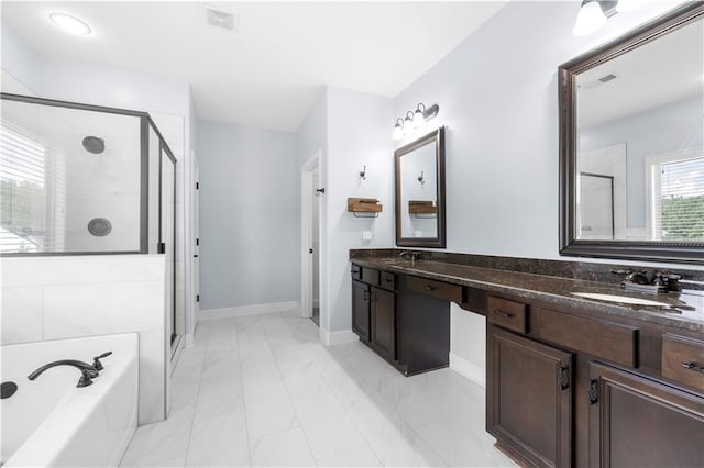 bathroom with vanity and shower with separate bathtub