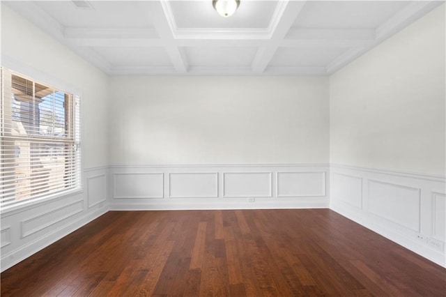 unfurnished room with beamed ceiling, coffered ceiling, and dark hardwood / wood-style flooring