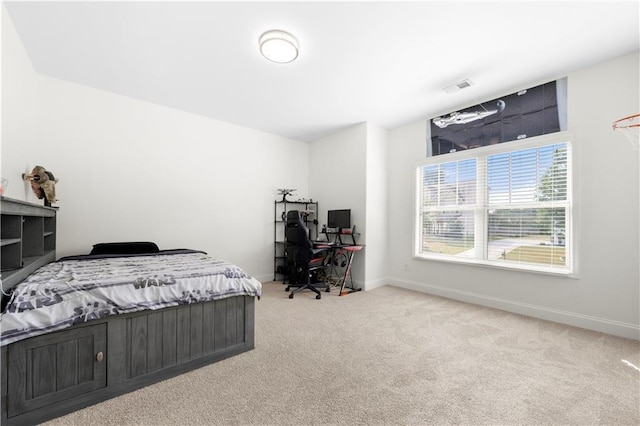 bedroom featuring light carpet