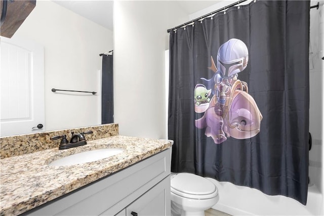 full bathroom with vanity, shower / bath combo, and toilet