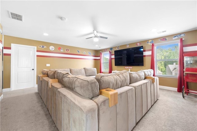 home theater room featuring ceiling fan and light carpet