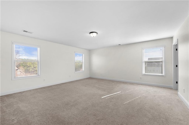 unfurnished room featuring light colored carpet