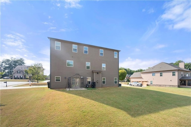 rear view of property featuring a yard