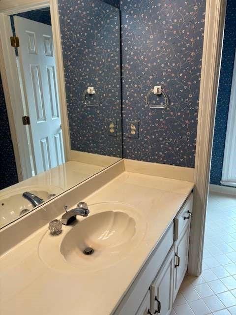 bathroom featuring wallpapered walls, vanity, and tile patterned flooring