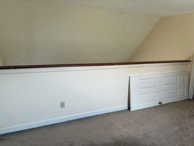 bonus room featuring baseboards, lofted ceiling, and carpet floors