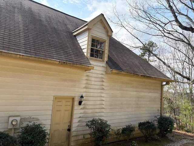 exterior space with a shingled roof