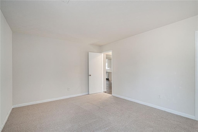 spare room with light colored carpet