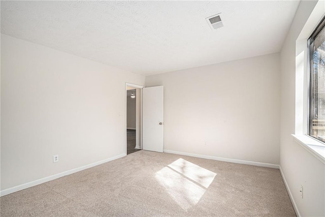 unfurnished room featuring carpet flooring