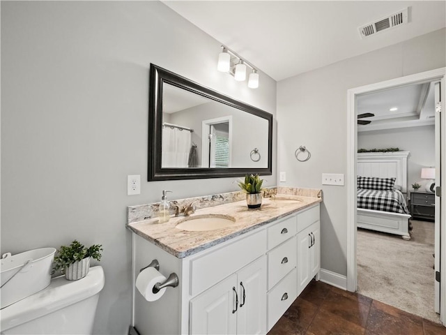 bathroom featuring toilet and vanity