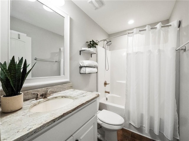 full bathroom featuring tile patterned flooring, shower / bath combination with curtain, vanity, and toilet