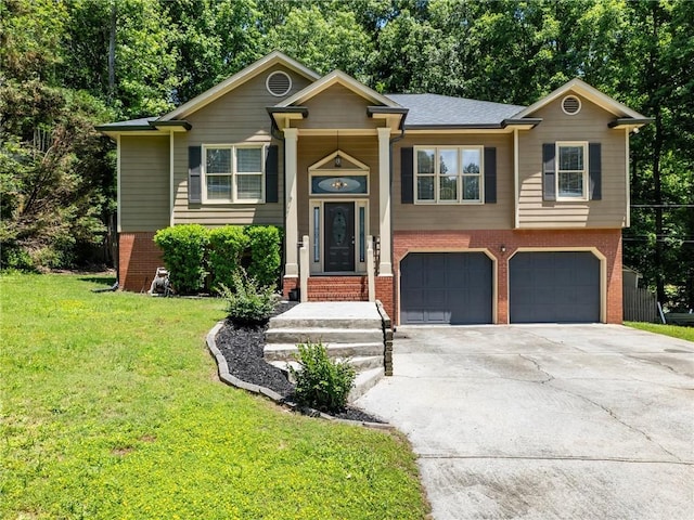 bi-level home featuring brick siding, an attached garage, driveway, and a front yard