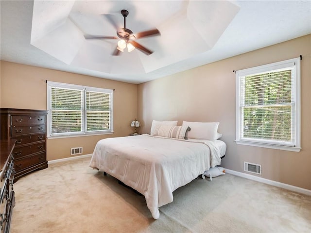 bedroom with baseboards, light carpet, and a ceiling fan