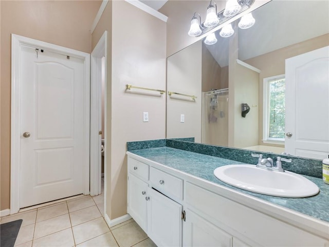 bathroom with tile patterned flooring, a shower, vanity, and baseboards